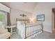 Bedroom with neutral walls, accent chair, and metal frame bed at 3235 Munsey Ct, Cumming, GA 30041
