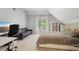 Bedroom features a bed, large window with natural light, and functional furniture at 3235 Munsey Ct, Cumming, GA 30041