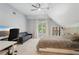 Inviting bedroom featuring a ceiling fan, a cozy couch, and a well-lit desk area at 3235 Munsey Ct, Cumming, GA 30041