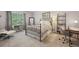 Bright bedroom with a large window, cozy bed, desk, and ample space at 3235 Munsey Ct, Cumming, GA 30041