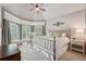 Cozy bedroom featuring a metal-framed bed, soft neutral tones, and a bay window for natural light at 3235 Munsey Ct, Cumming, GA 30041