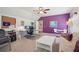 Well-lit, flexible bonus room features a futon, working space, and ample natural light for comfort and utility at 3235 Munsey Ct, Cumming, GA 30041