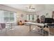 Bonus room with carpet, futon, fan, windows, round table and chairs, and work-from-home space at 3235 Munsey Ct, Cumming, GA 30041