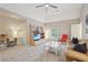 Versatile bonus room with a ceiling fan, a comfortable sofa, and a dedicated workspace at 3235 Munsey Ct, Cumming, GA 30041