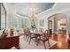Elegant dining room with bay window, wood table and chairs, and coffered ceiling creating a perfect ambiance at 3235 Munsey Ct, Cumming, GA 30041