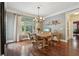 Charming dining room with hardwood floors, neutral walls, and large window offering lots of natural light at 3235 Munsey Ct, Cumming, GA 30041