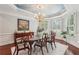Dining room boasts hardwood floors, an elegant chandelier, and bay windows with lots of natural light at 3235 Munsey Ct, Cumming, GA 30041
