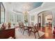 Formal dining room featuring a beautiful chandelier, bay window, and elegant decor at 3235 Munsey Ct, Cumming, GA 30041