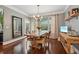 Dining room with hardwood floors, modern chandelier, and bright natural light at 3235 Munsey Ct, Cumming, GA 30041