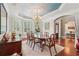 Elegant dining room with a large table, decorative ceiling, and arched entryway, perfect for entertaining at 3235 Munsey Ct, Cumming, GA 30041