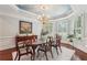 Elegant dining room featuring hardwood floors, neutral walls, and large windows offering lots of natural light at 3235 Munsey Ct, Cumming, GA 30041