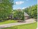 Beautiful home featuring a long, curved driveway lined with mature trees at 3235 Munsey Ct, Cumming, GA 30041