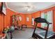 Brightly painted home gym with rubber floors, workout equipment and space for any fitness enthusiast at 3235 Munsey Ct, Cumming, GA 30041