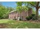 Exterior view of the home displaying mature landscaping, brick facade, and well maintained yard at 3235 Munsey Ct, Cumming, GA 30041