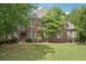 Charming brick home with manicured lawn and mature landscaping at 3235 Munsey Ct, Cumming, GA 30041