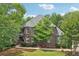 Charming brick home featuring a well-manicured lawn and mature trees at 3235 Munsey Ct, Cumming, GA 30041