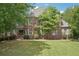 Charming brick home with well-manicured lawn and mature trees at 3235 Munsey Ct, Cumming, GA 30041
