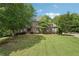 Well-maintained brick home with a manicured lawn and mature trees at 3235 Munsey Ct, Cumming, GA 30041