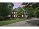Charming two-story brick home with lush landscaping and a circular driveway at 3235 Munsey Ct, Cumming, GA 30041