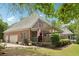 Charming brick home featuring an attached garage, cozy covered porch, and landscaped yard at 3235 Munsey Ct, Cumming, GA 30041