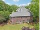 Spacious brick home featuring a well-maintained lawn and mature trees at 3235 Munsey Ct, Cumming, GA 30041