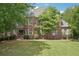 Charming brick home with manicured lawn and traditional design elements at 3235 Munsey Ct, Cumming, GA 30041