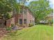 Attractive brick home with lush landscaping and a well-manicured lawn at 3235 Munsey Ct, Cumming, GA 30041