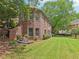Two-story brick home featuring lush landscaping and a well-maintained lawn in a serene residential setting at 3235 Munsey Ct, Cumming, GA 30041