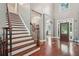 Inviting foyer with hardwood floors, staircase, and plenty of natural light at 3235 Munsey Ct, Cumming, GA 30041