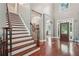 Grand foyer with hardwood floors, staircase, and ample natural light at 3235 Munsey Ct, Cumming, GA 30041