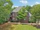 Charming front exterior with lush greenery, a well-manicured lawn, and inviting curb appeal at 3235 Munsey Ct, Cumming, GA 30041