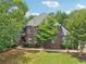 Stately brick home with a manicured lawn and mature trees at 3235 Munsey Ct, Cumming, GA 30041