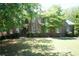 Charming brick home with manicured lawn and mature trees, offering a welcoming curb appeal at 3235 Munsey Ct, Cumming, GA 30041