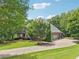 A large brick home with attached garage sits on a beautifully manicured lawn at 3235 Munsey Ct, Cumming, GA 30041