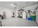 Spacious garage featuring ample storage, gray epoxy flooring, and convenient organization at 3235 Munsey Ct, Cumming, GA 30041