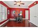Home office with hardwood floors, large windows with plantation shutters, and a ceiling fan at 3235 Munsey Ct, Cumming, GA 30041