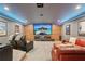 Home theater with a large screen, comfortable seating, wood accent wall, and theater decor at 3235 Munsey Ct, Cumming, GA 30041
