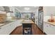 Spacious kitchen features white cabinets, stainless appliances, granite countertops, and a functional island workstation at 3235 Munsey Ct, Cumming, GA 30041