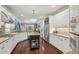 Bright kitchen featuring white cabinets, stainless appliances, granite countertops, and a center island with seating at 3235 Munsey Ct, Cumming, GA 30041