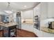 The gourmet kitchen features an island, stainless steel appliances, a wine rack, and granite countertops at 3235 Munsey Ct, Cumming, GA 30041