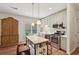 Bright eat-in kitchen with shaker cabinets, stainless steel appliances, and island with seating at 3235 Munsey Ct, Cumming, GA 30041