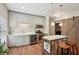 Bright kitchen offers stainless steel appliances, shaker cabinets, and a large island with seating at 3235 Munsey Ct, Cumming, GA 30041