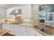 Close up of kitchen with white cabinets, stainless appliances, granite countertops and stainless steel hood at 3235 Munsey Ct, Cumming, GA 30041