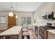 Modern kitchen with stainless steel appliances, cream cabinets, marble countertop island, and hardwood floors at 3235 Munsey Ct, Cumming, GA 30041