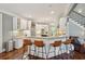 Bright kitchen featuring white cabinets, granite countertops, stainless appliances, and an island with bar seating at 3235 Munsey Ct, Cumming, GA 30041