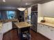 Bright, updated kitchen with granite countertops, stainless steel appliances, central island and adjoining living area at 3235 Munsey Ct, Cumming, GA 30041