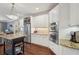 Well-equipped kitchen features stainless steel appliances, a wine rack, white cabinets, and a center island at 3235 Munsey Ct, Cumming, GA 30041