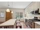 Bright kitchen featuring stainless steel appliances, an island with seating, and ample cabinet space at 3235 Munsey Ct, Cumming, GA 30041