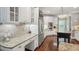 Bright kitchen features white cabinets, stainless appliances, granite countertops, and an adjacent workstation at 3235 Munsey Ct, Cumming, GA 30041