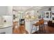 Bright eat-in kitchen featuring granite counters, a central island, stainless appliances and hardwood floors at 3235 Munsey Ct, Cumming, GA 30041